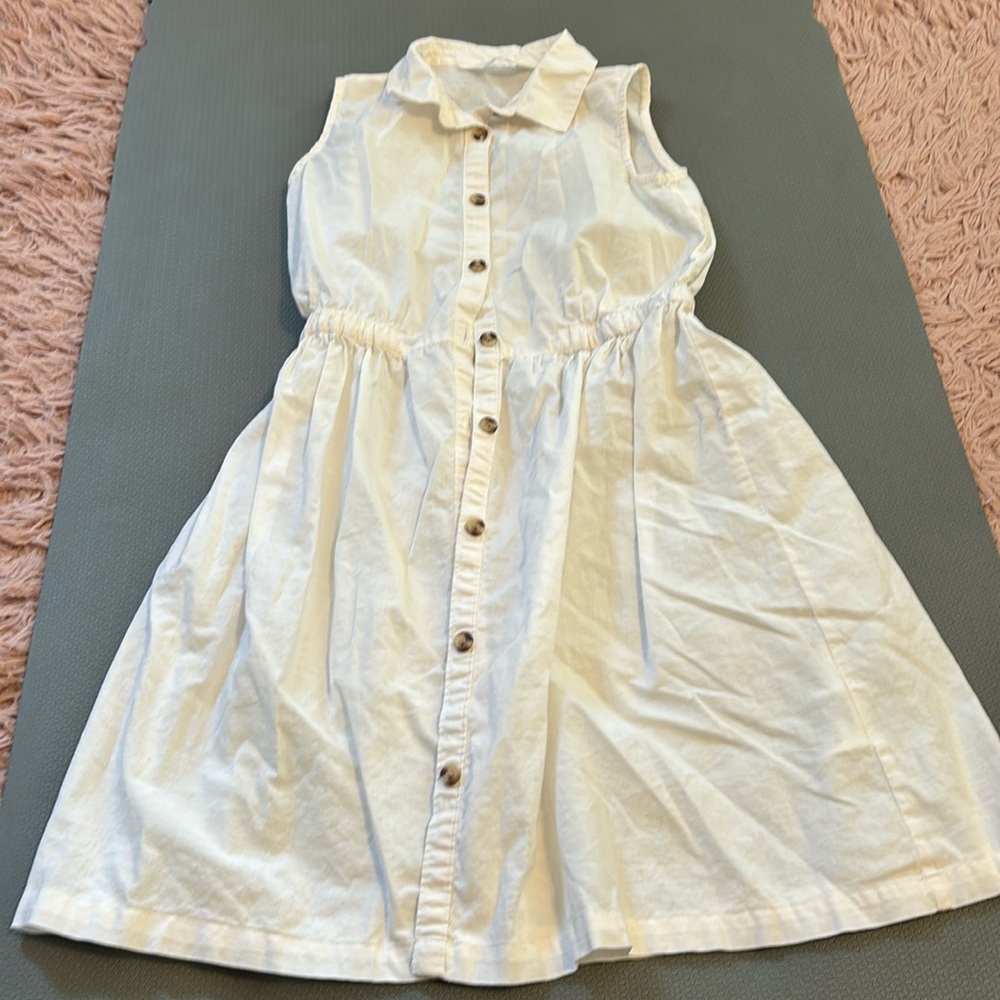 Girls H&M size 10 sleeveless cream dress and buttons from top to bottom.